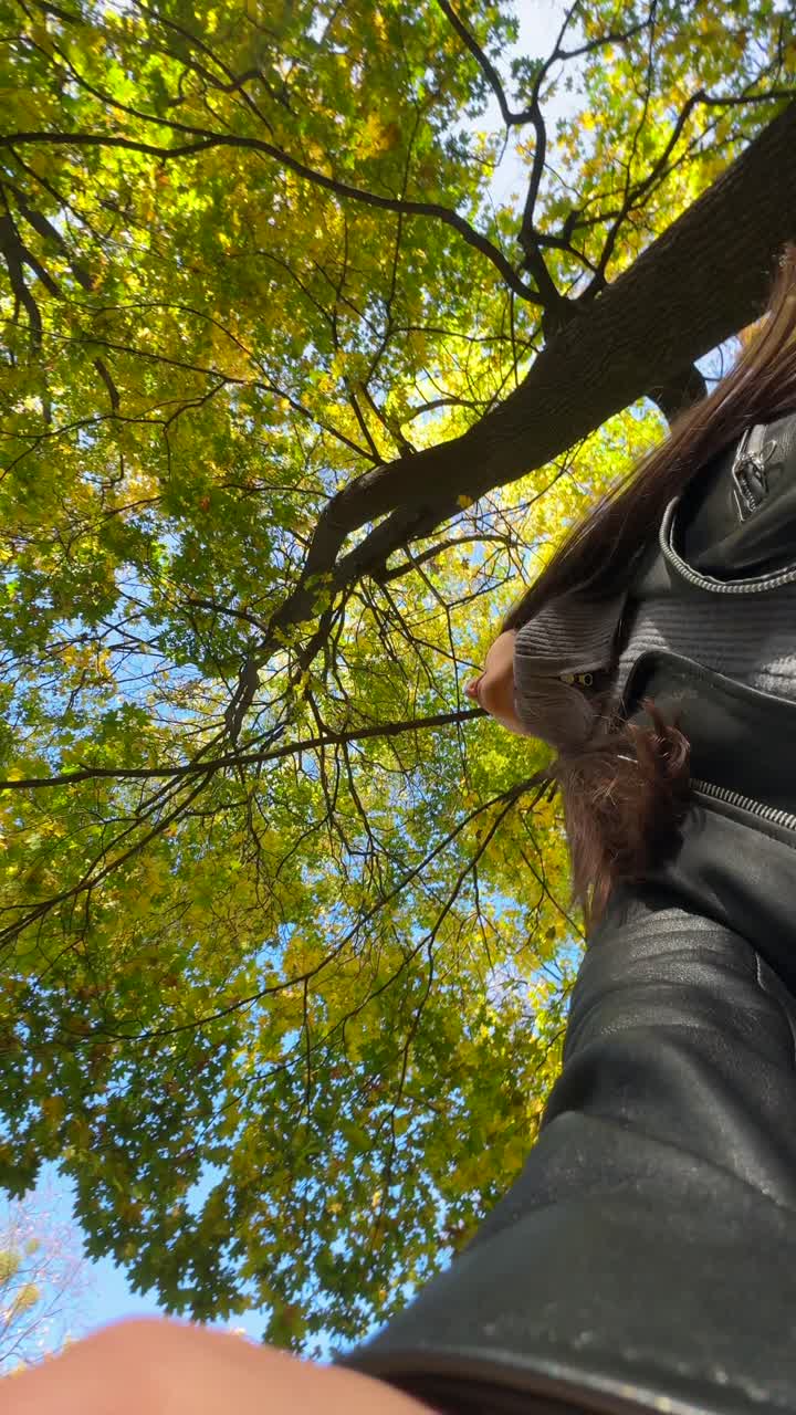 mujer bajo los árboles de otoño