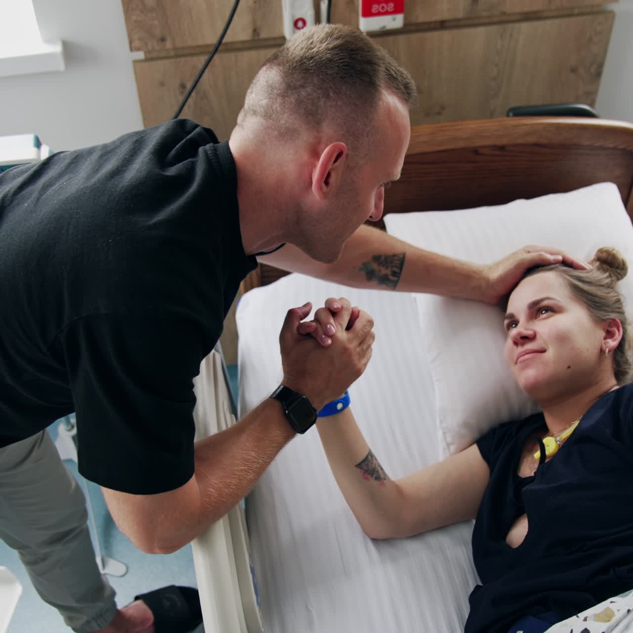 Clinic healthcare pregnancy support. Young family in hospital room