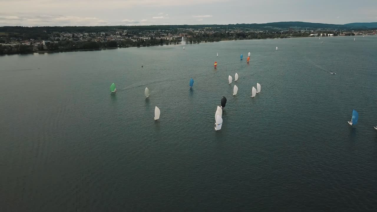 An orbit shot of a sailboat race in the Alpine foreland