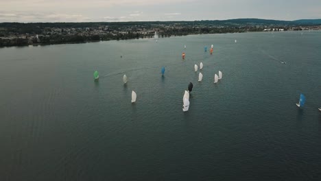 an orbit shot of a sailboat race in the alpine foreland