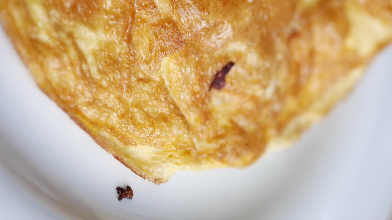 Close-up of Golden Baked Food with Savory Filling and Vegetables