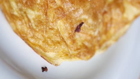 close-up of golden baked food with savory filling and vegetables
