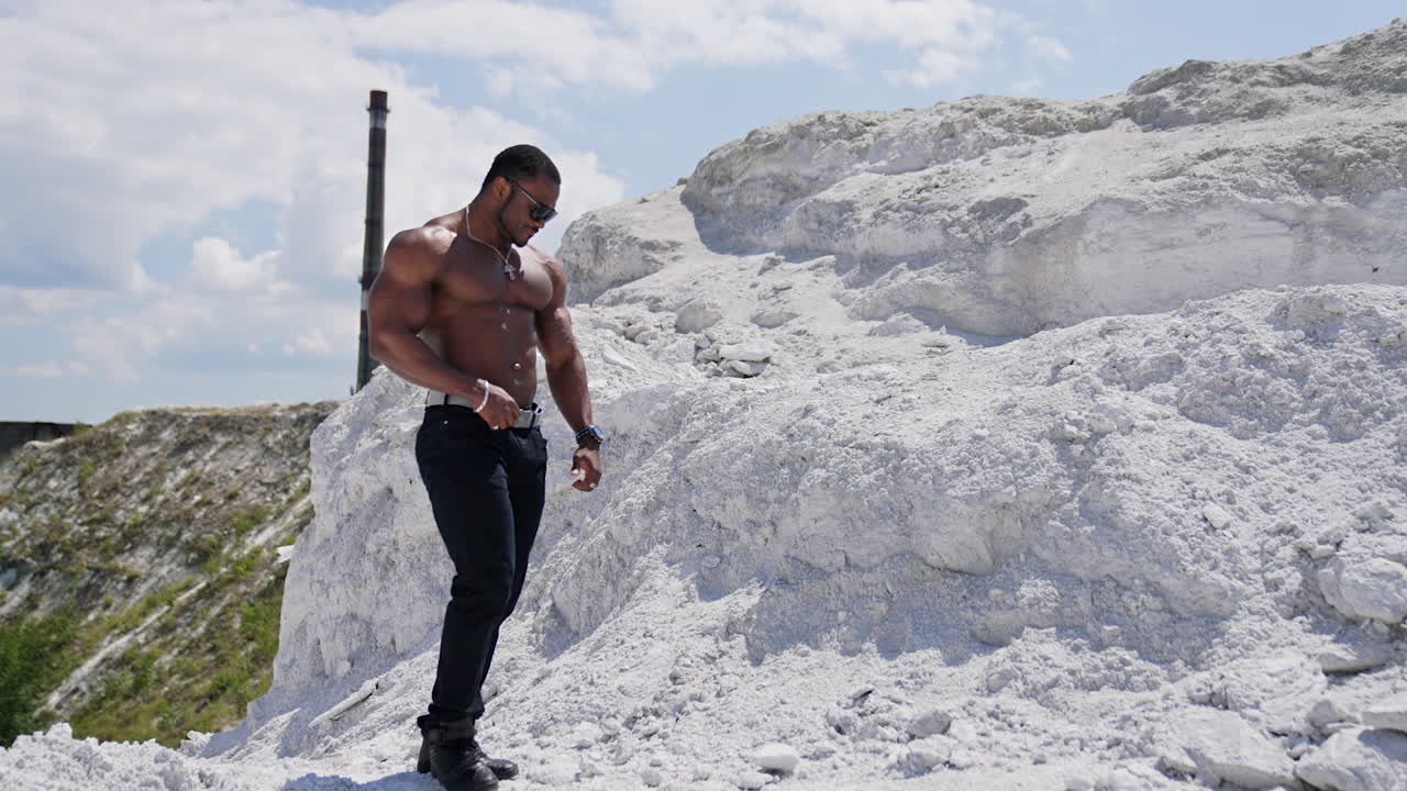 Fit young man with beautiful torso. Naked torso of african american man posing outdoor