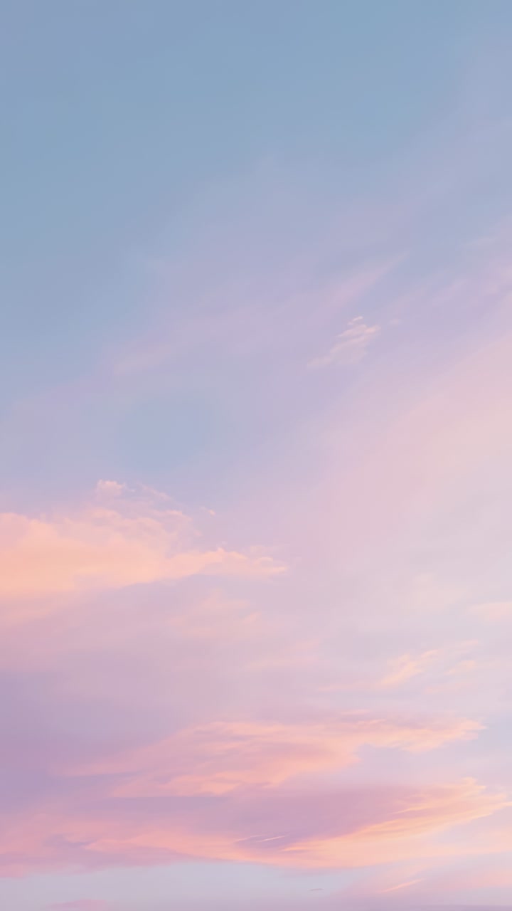 Vertical video: Shifting pink cloud band moving at sunrise, showing small puff and sky hue