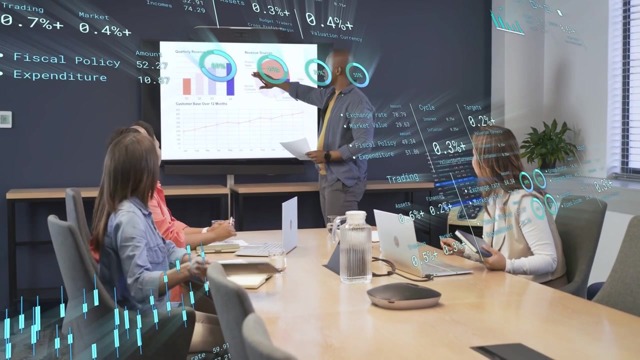 Presenter standing and pointing, team taking notes reviewing finance charts as AR overlay updating
