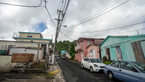 time lapse of moving clouds over cayey city suburbia, street and cars, puerto rico
