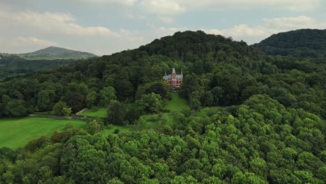 Surrounded-by-woodland,-siting-on-slope-hilly-slope,-beautiful-architecture