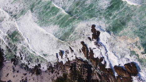 incessant wave action slamming rocks on coastline