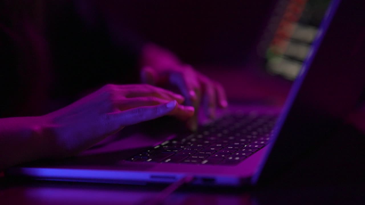 Person Typing on Laptop at Night