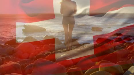 Animation-of-flag-of-switzerland-over-caucasian-woman-at-beach
