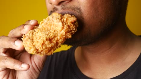 man eating fried chicken