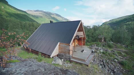 dog resting in unique cottage in lyngsdalen valley norway - wideshot