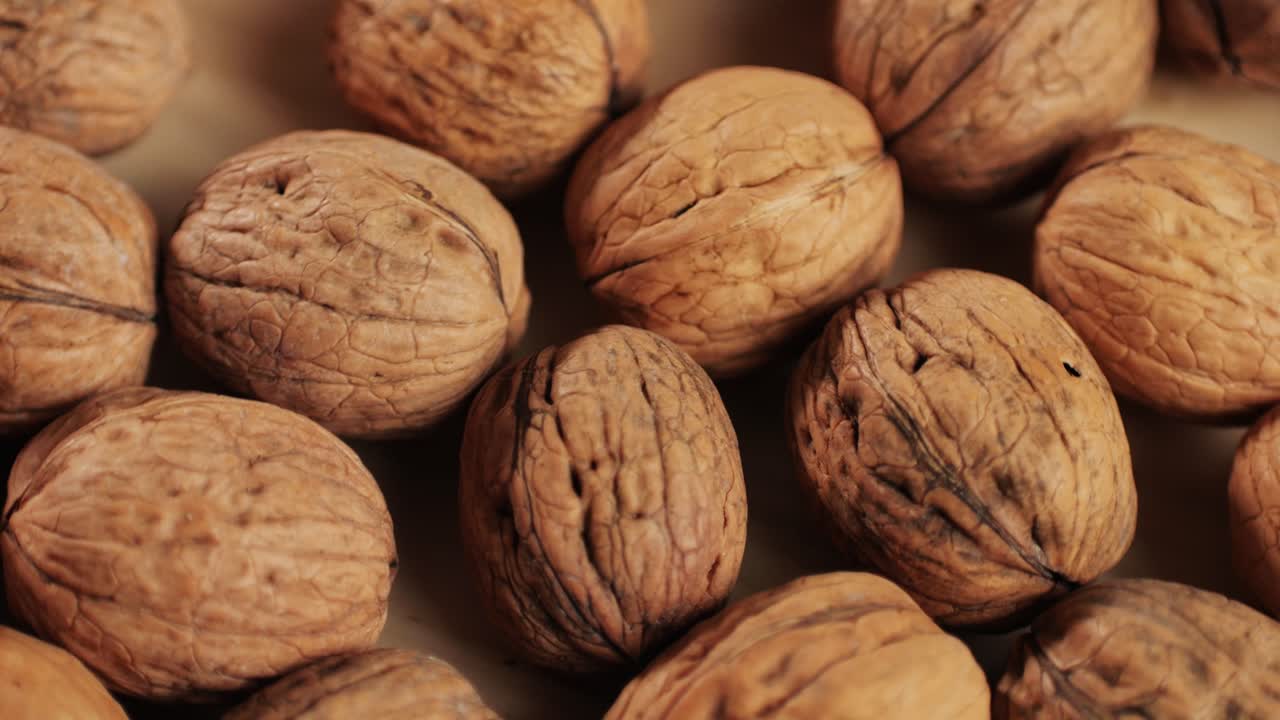 Walnuts in a shell rotating top view. Healthy snacks. Product rich in minerals and vitamins. High quality 4k footage