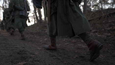 german soldiers marching in a forest during world war ii