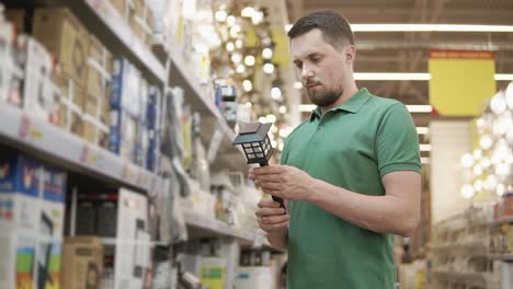 man shopping for solar garden lights in a home improvement store