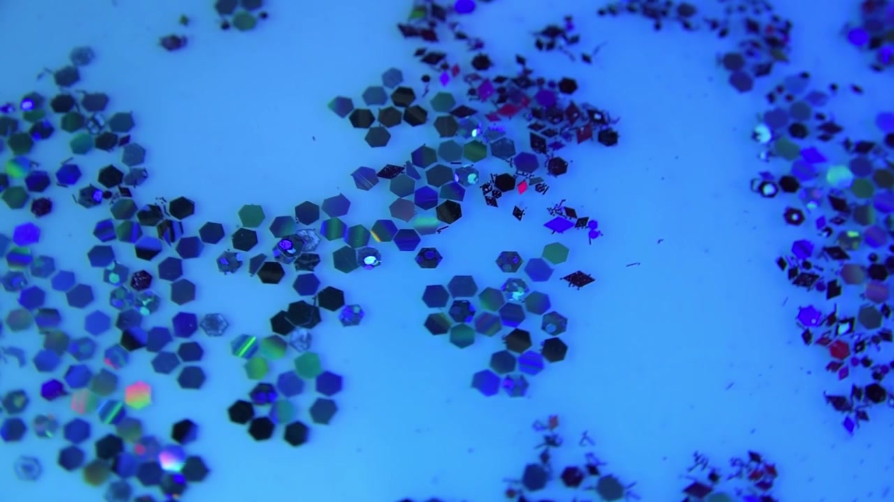 Glitter particles under colored light