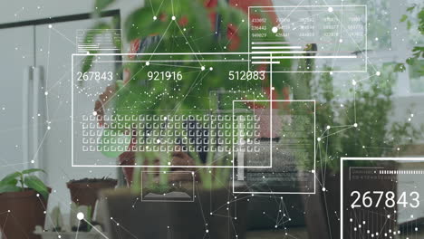 animation of data processing over biracial woman nurturing plants at home