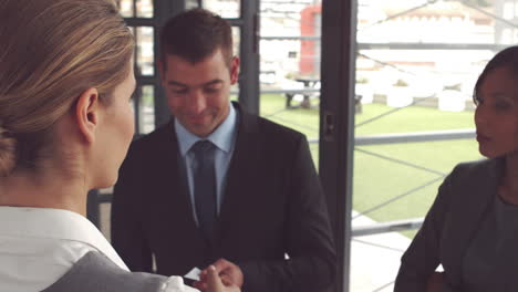 Businesswoman-giving-business-card-and-handshake