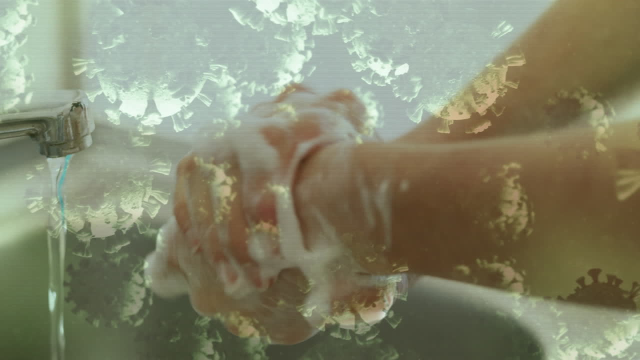 손을  ⁇ 는 사람 위의 코로나 19 세포의 애니메이션