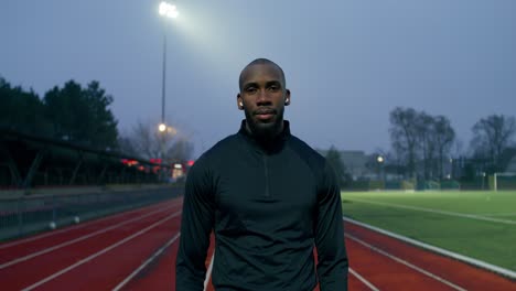 man on a running track at night