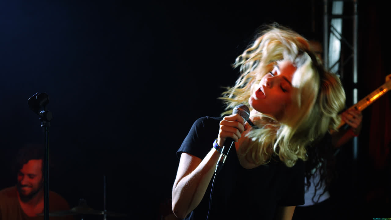 Singer performing on stage at a concert 4k