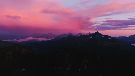 heavenly peaks, aerial footage of majestic mountains under a surreal pink sky (high-res footage)