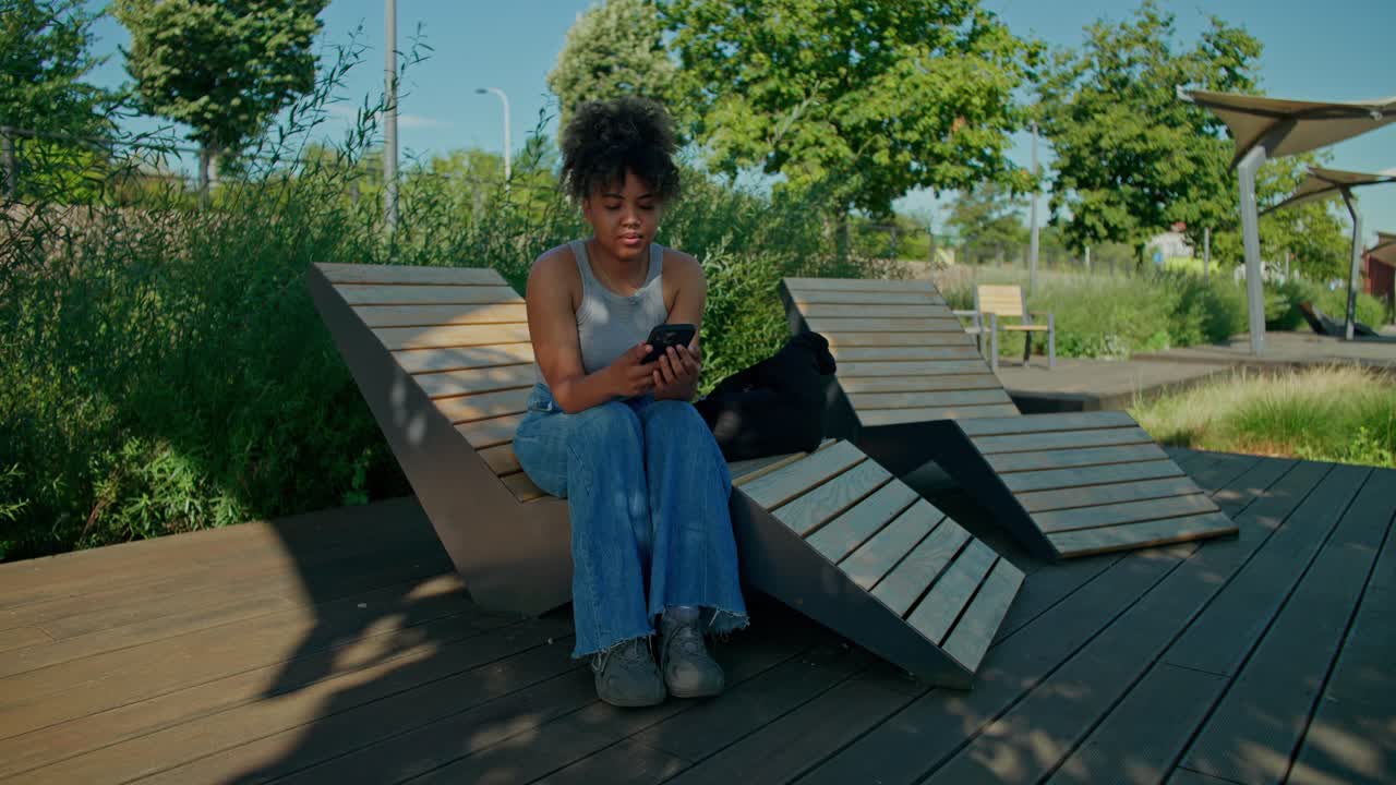 Woman relaxing in a park on a lounger