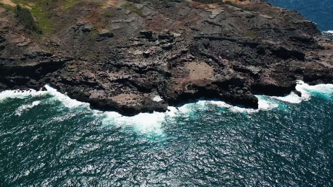 Aerial View of Rocky Coastline with Crashing Ocean Waves