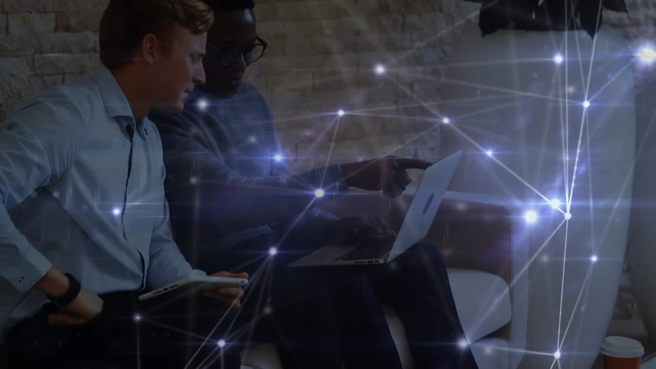 Glowing network of connections against office colleagues using electronic devices