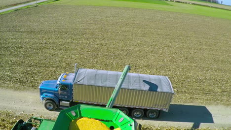 excellent aerial over a rural american farm with corn combine harvester at work 2