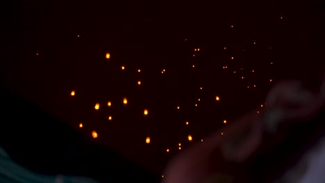 beautiful paper sky lanterns floating in sky at night