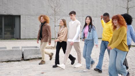 multi-ethnic students chatting and walking along the campus