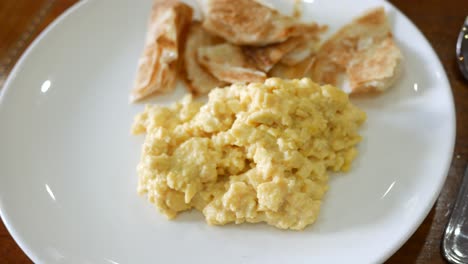 fried eggs mixed with bread on plate ,