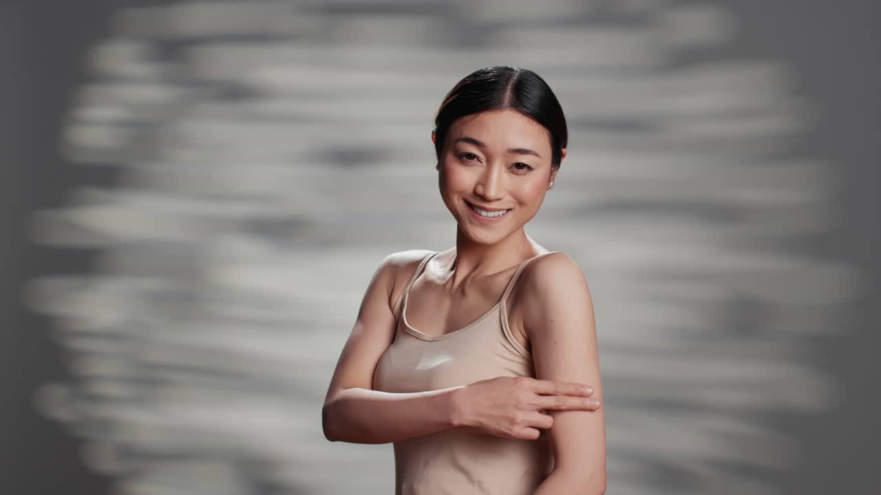 Beautiful Asian woman touching her skin