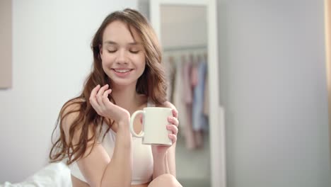 young woman enjoy morning coffee in bed. portrait of happy woman