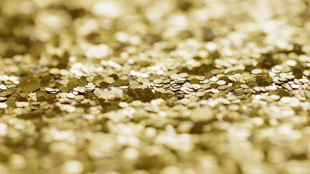 Macro sliding view of gold glitter