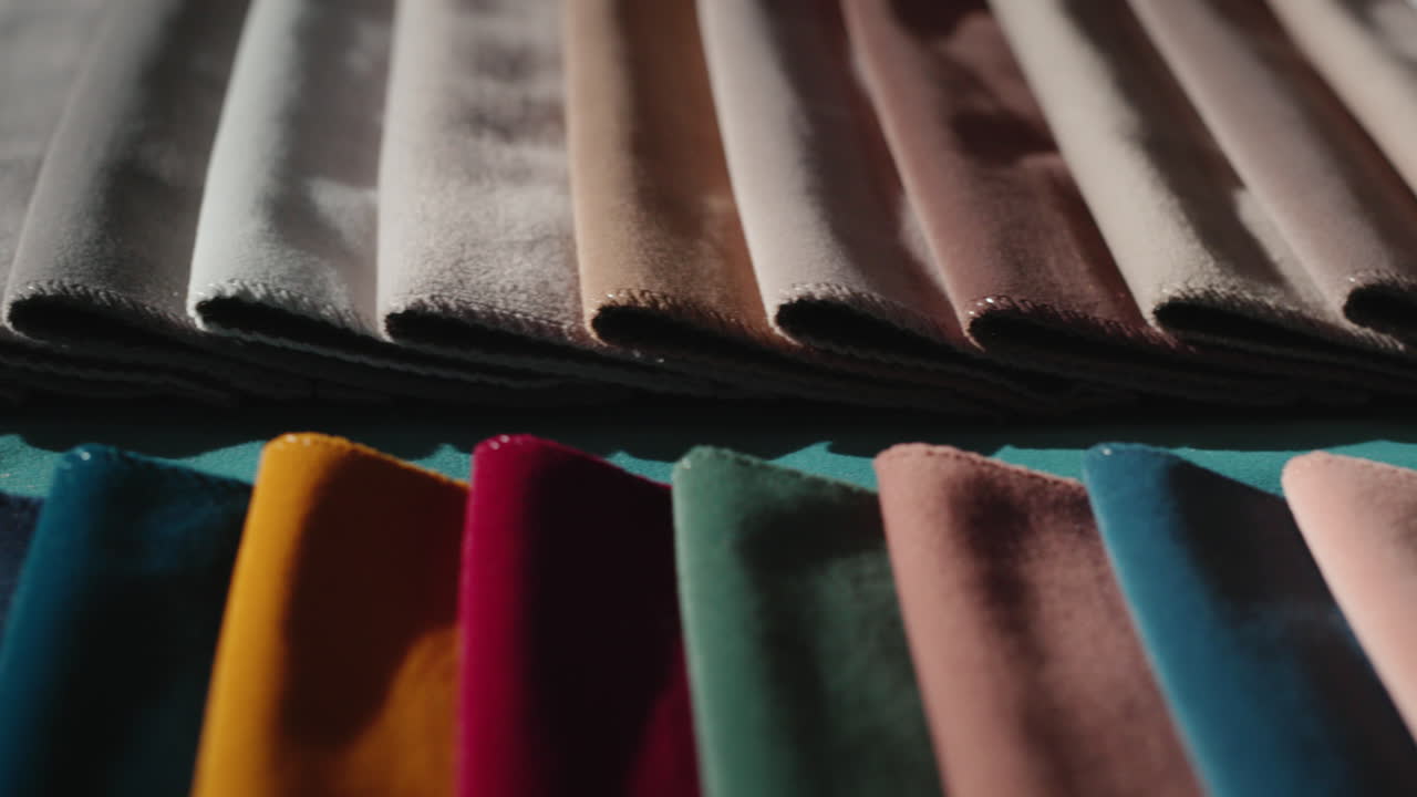 Samples of multi-colored fabric on the counter in the store. Slider 4k shot
