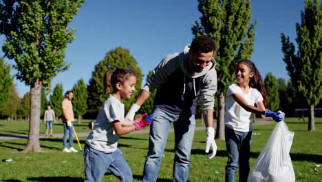 family volunteering at park cleanup