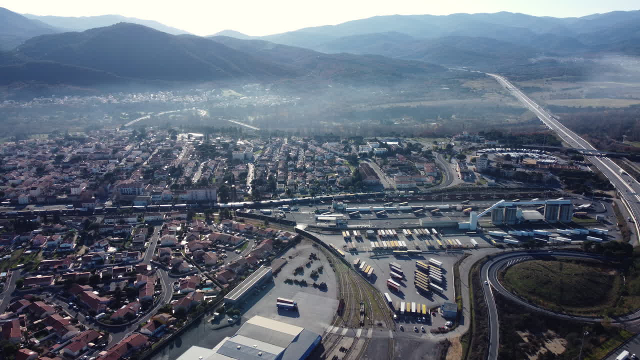 Aerial View of a City with a Train Station and Freight Terminal