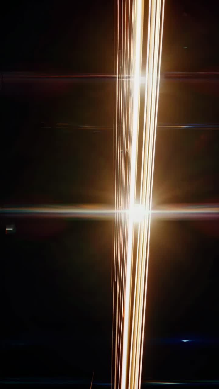Abstract video art with diagonal light streaks against a dark background