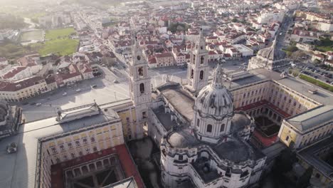 Aerial-overlooking-Royal-Palace,-Mafra-cityscape-in-background