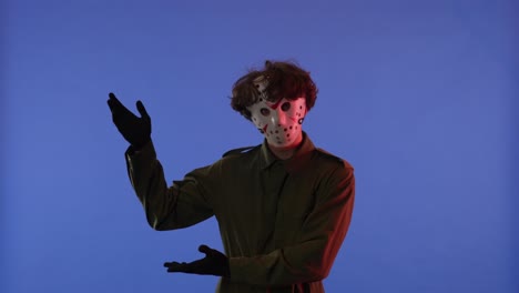 man in white mask pointing his hand in the direction and then does the like gesture on blue