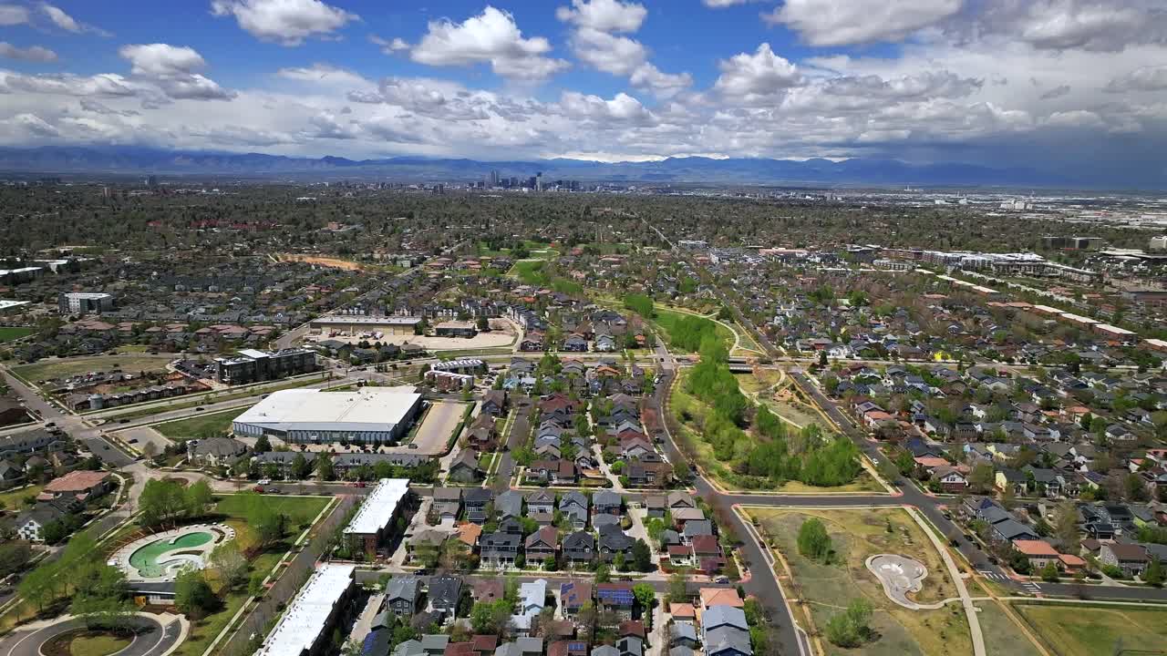 Front Range Denver Lowry Northfield Central Park neighborhood apartment buildings Colorado aerial drone sunny cloudy sky cloudy Lakewood Arvada Golden cars cityscape skyscrapers forward pan up motion