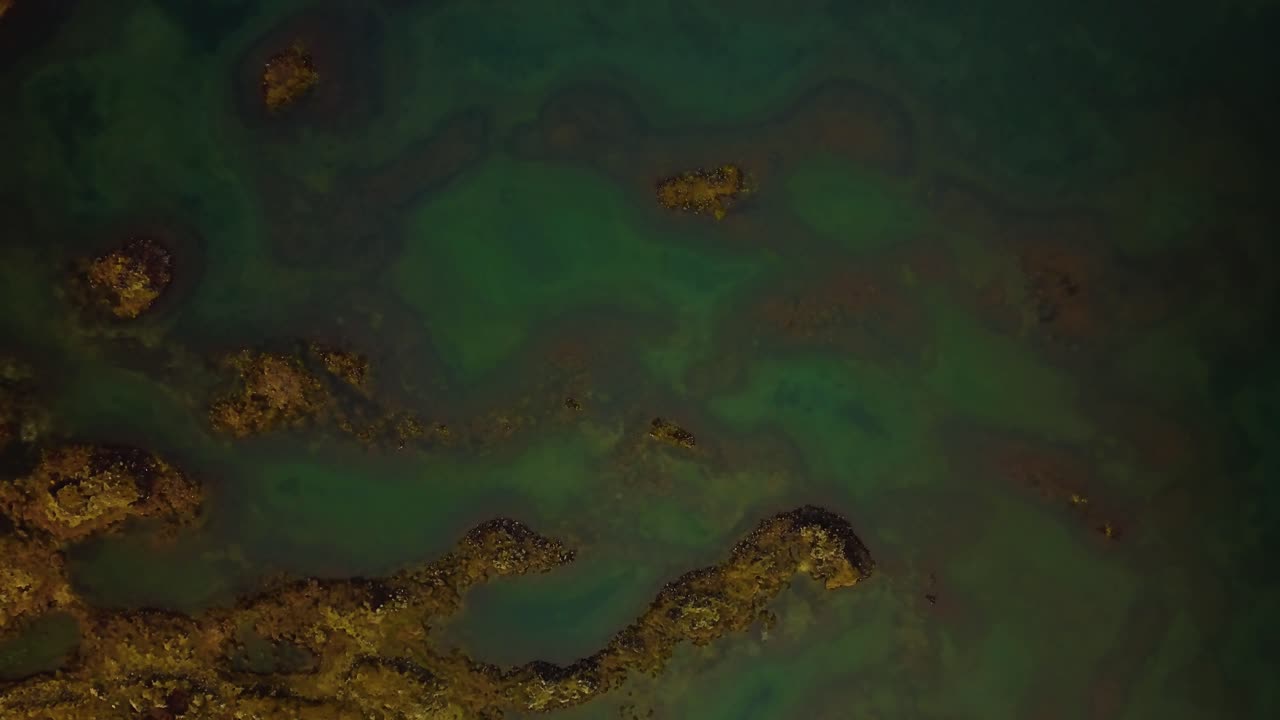 Aerial view over natural textures and patterns of the Icelandic highlands terrain and water ponds