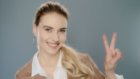 young business woman showing victory sign