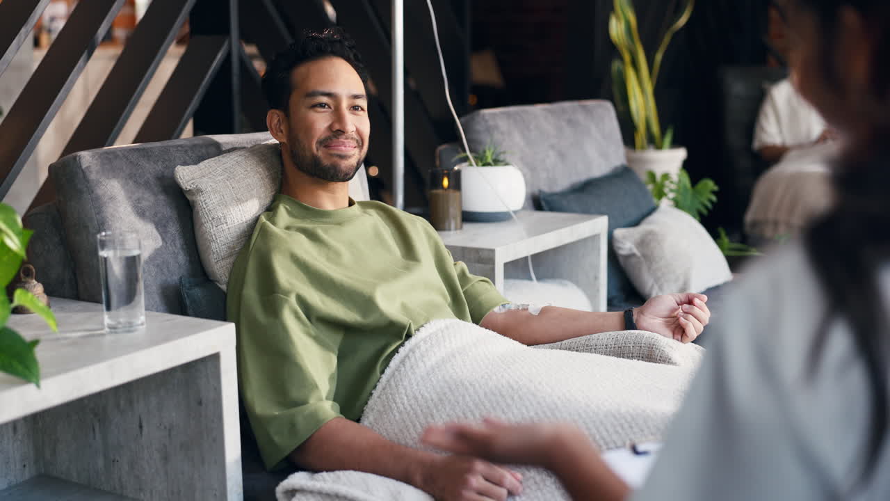 Young Man Smiling While Receiving IV Drip Therapy