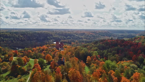 aerial - scenic shot of medieval turaida castle with forest at autumn in latvia