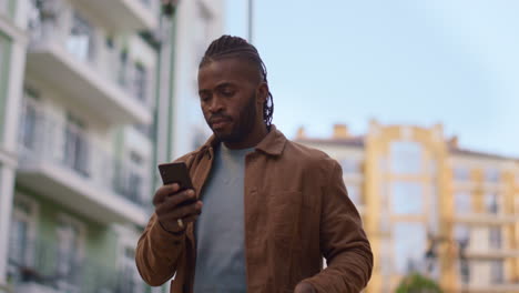 casual man making phone call walk city street portrait. urban lifestyle concept