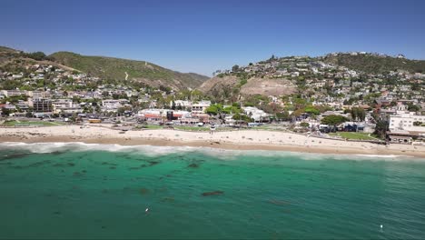 flying over the pacific ocean and towards main beach in laguna beach california