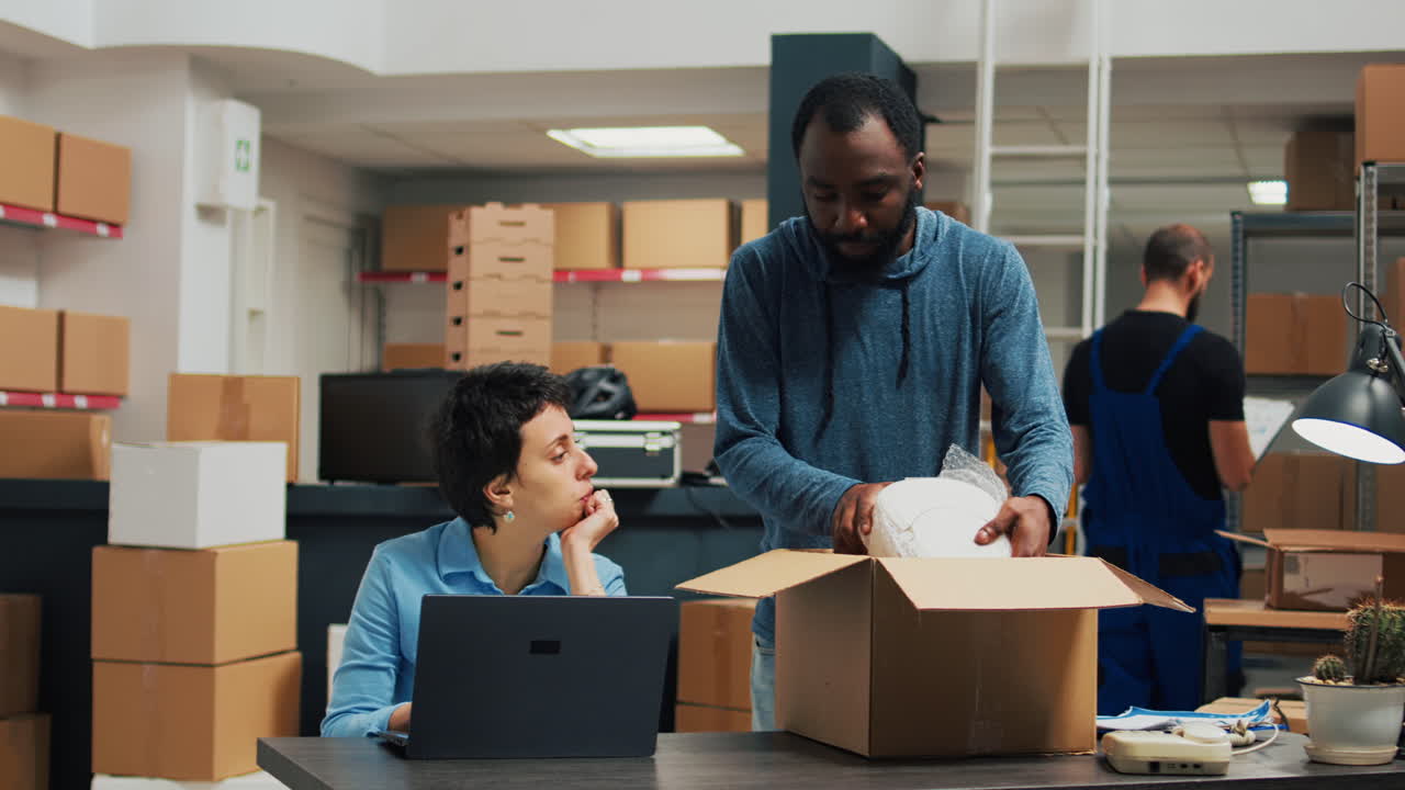 People in a warehouse packing boxes